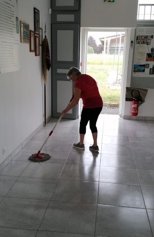 Chantal mops the floor of the “Armée de Terre” room